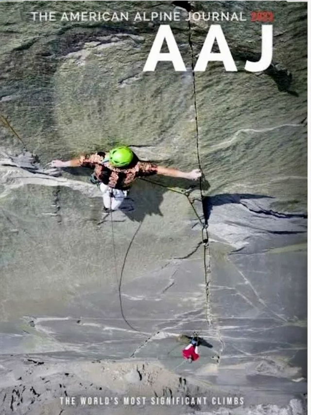 A man is climbing up the side of a rock wall.